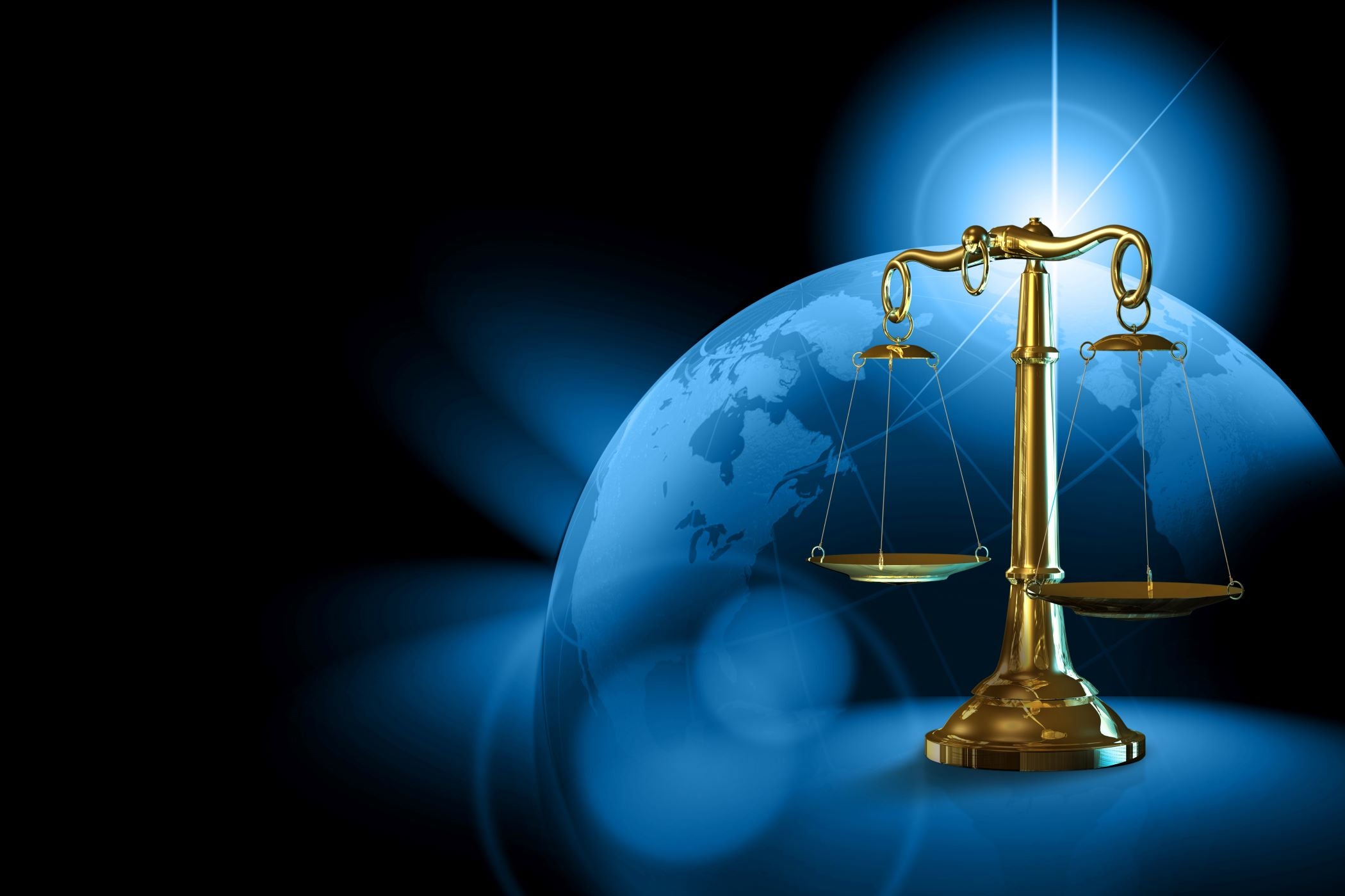 Gold balance scale on a blue globe with a dark background symbolising Dame Jo!'s pledge to making skincare that is balance - no underuse, no overuse.