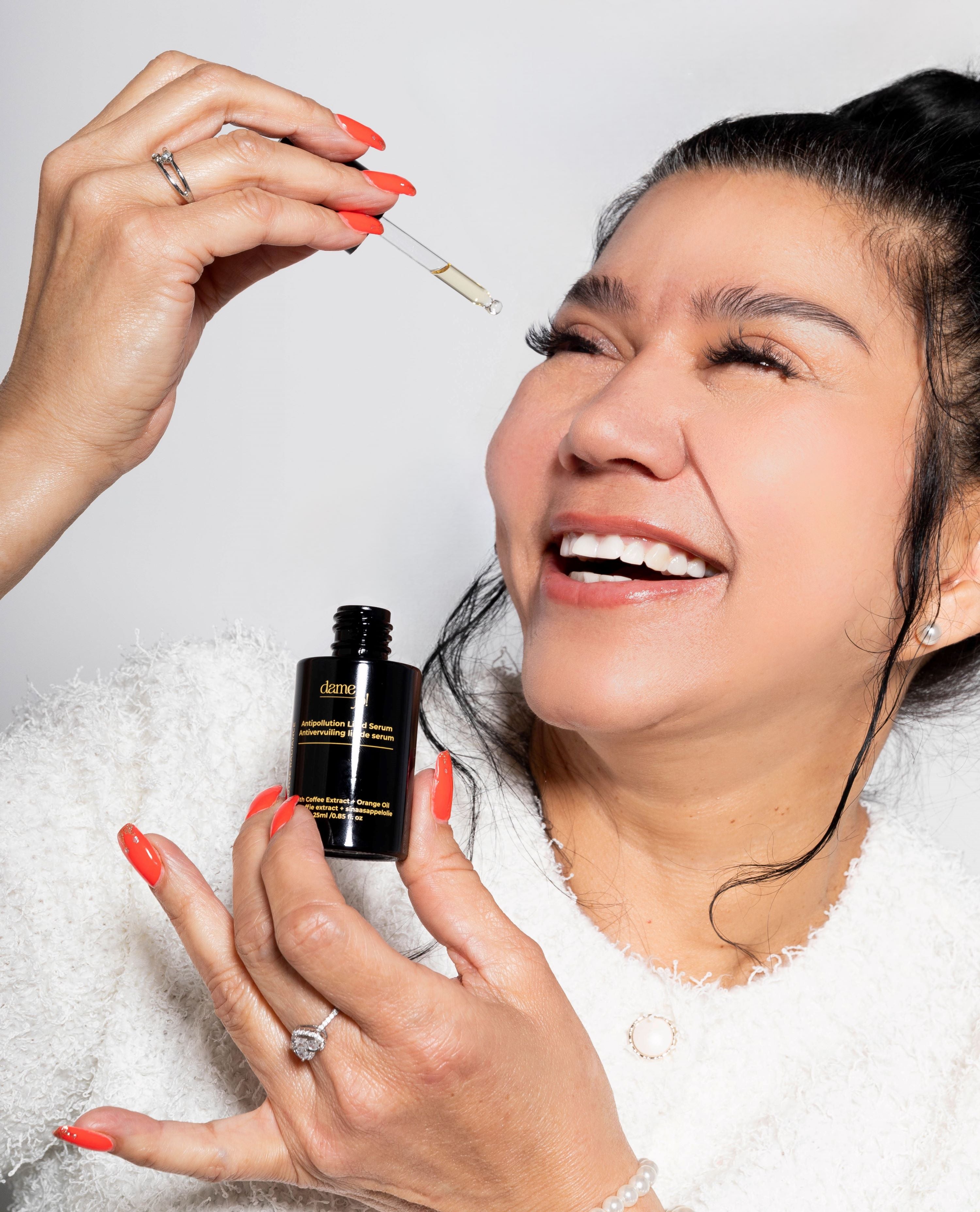 Elegant product shot of Executive Radiance serum with model in background.